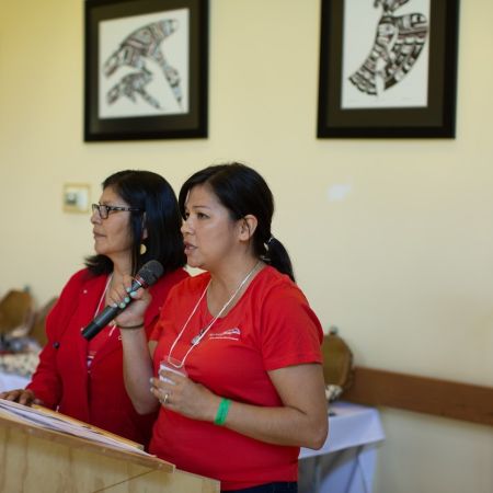 Two individuals speaking at the cultural gathering